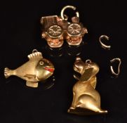 Three 9ct gold charms including dog, fish and train, 4.9g