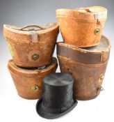 Four vintage leather hat cases or boxes including a double example, some with railway luggage