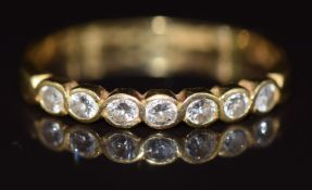 An 18ct gold half eternity ring set with seven diamonds, 2.1g, size P