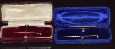 A 9ct gold stud set with onyx and a seed pearl with stick pin attachments