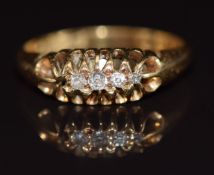 An 18ct gold ring set with four diamonds (one missing), 3.1g, size L