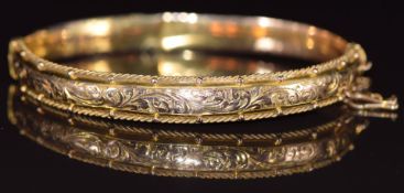 A 9ct gold bangle with engraved, rope twist and sphere decoration, Birmingham 1913, 8.7g