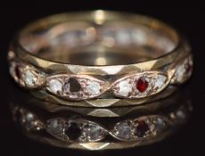 A 9ct gold eternity ring set with garnets and spinel, 2.7g, size P