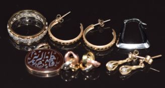 A 9ct gold eternity ring set with spinel, a 9ct gold pendant set with a carved agate plaque and