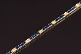 An 18ct gold bracelet set with diamonds and calibre cut sapphires, 15.5g 18.5cm