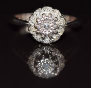 An 18ct white gold ring set with diamonds in a cluster, 3.8g, size L