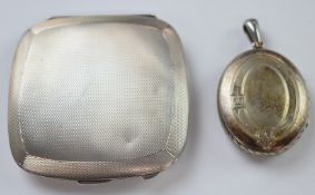 A silver compact with engine turned decoration and Victorian silver locket with engraved bird