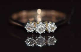 A 9ct gold ring set with three diamonds in a platinum setting, 1.7g, size J/K
