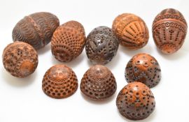 Eight carved coquilla nut thimble / thread holders, tallest 6cm