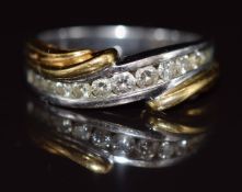 An 18k bi-coloured gold ring set with graduated diamonds, 6.2g, size O