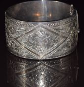 A silver bangle with engraved decoration, 69g