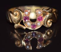 A late Victorian 15ct gold ring in the form of a horseshoe set with rubies and pearls, Birmingham
