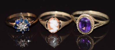 Three 9ct gold rings, one set with a diamond and sapphires, one an amethyst and the other a cameo,