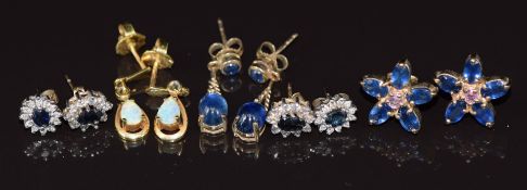 Five pairs of 9ct gold earrings set with sapphire cabochons, sapphire floral cluster, opal, sapphire