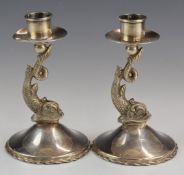 Pair of silver candlesticks with figural dolphin supports, marked to bases with 800 grade marks,