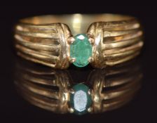 An 18ct gold ring set with an oval cut emerald, 3.3g, size M