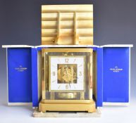 Jaeger Le Coultre Atmos clock, in gilt and glazed case, the white square with applied gilt numerals,