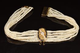 A nine strand pearl necklace with detachable 18ct gold pendant with pierced honeycomb decoration set