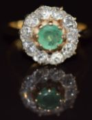 An 18ct gold ring set with a round cut emerald surrounded by old cut diamonds, 4.3g, size I