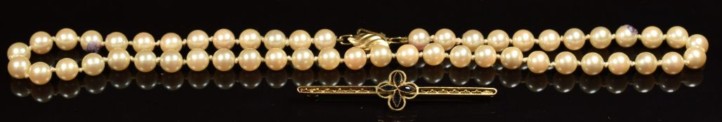 A 9ct gold brooch and a single strand of cultured pearls with 9ct gold clasp