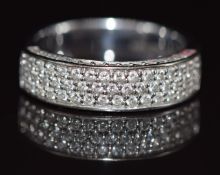 An 18ct white gold ring set with three rows of diamonds and further diamonds to the setting, 6.4g,