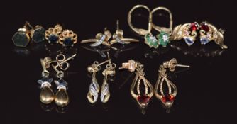 Eight pairs of 9ct gold earrings set with diamond and emeralds, garnets, sapphire, diamonds,