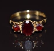 A 9ct gold ring set with three garnets, in vintage box, 2.2g, size N