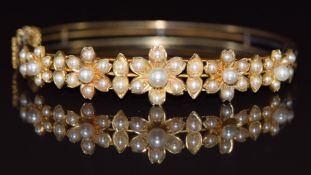 Edwardian 9ct gold bangle set with split pearls and pearls in a floral designs, 15g