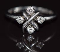 Tiffany & Co platinum ring set with four diamonds in a cross setting, maker 'Schlumberger Studios