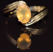A 9ct gold ring set with an oval cut opal, 2.7g, size M