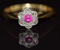 Art Deco 18ct gold ring set with a ruby surrounded by diamonds in a floral platinum setting, 2.5g,