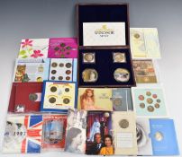 A collection of UK crowns and uncirculated coin collections in presentation packs including Queen