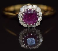 An 18ct gold ring set with a ruby of approximately 1ct surrounded by diamonds, 4.2g, size V