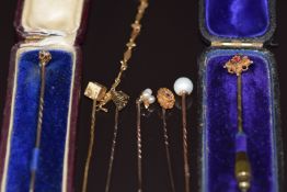 A collection of stick pins comprising 9ct gold set with a diamond, another 9ct gold set with
