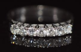 An 18ct white gold ring set with seven round cut diamonds, each approximately 0.08ct, 3.2g, size O
