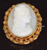 A late Victorian yellow metal brooch in the form of shells and spheres set with a cameo