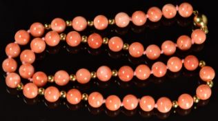 A necklace of coral and 18ct gold beads with 18ct gold clasp