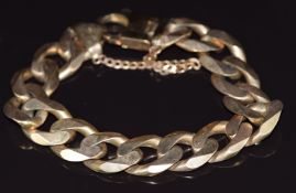 A large 9ct gold curb link bracelet, 89g