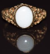 A 9ct gold ring set with a white opal, with pierced textured shoulders, 3g, size R