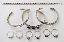 Six silver rings, three silver bangles including amethyst, and rope twist bracelet