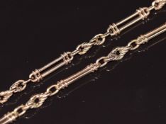 A c1900 9ct rose gold watch chain/ necklace made up of elongated and knotted links, 37.6g, 73cm