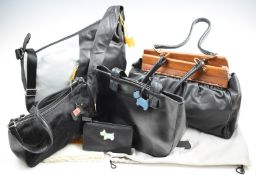 Four Radley handbags in black and a purse, all with dust bags