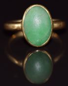 An 18ct gold ring set with a jadeite cabochon, 3.7g, size G