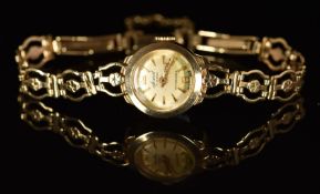 Accurist 9ct gold ladies wristwatch with gold hands and hour markers, silver dial and mechanical