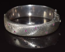 Hallmarked silver bangle set with synthetic rubies in star settings