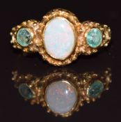 A 9ct gold ring set with an opal and emeralds, 1.9g, size I