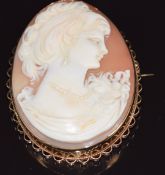 A 9ct gold brooch set with a cameo depicting a young woman