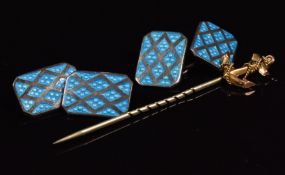 A pair of silver cufflinks set with enamel and 9ct gold anchor stick pin