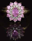 A 9ct gold ring set with pink sapphires and diamonds in a cluster, 2.5g, size P