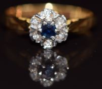An 18ct gold ring set with a sapphire surrounded by diamonds, 3g, size M